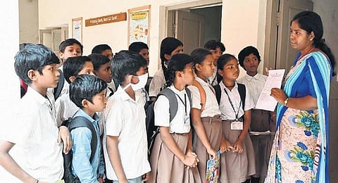 A teacher guides students before the exam on Monday. (Photo | Nagaraja Gadekal, EPS)