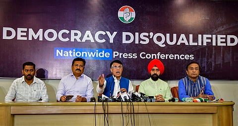 Congress' Pawan Khera (C) along with Atul Londhe (L) and Charan Singh Sapra addresses a press conference on the disqualification of Rahul Gandhi from Lok Sabha, in Mumbai. (Photo | PTI)