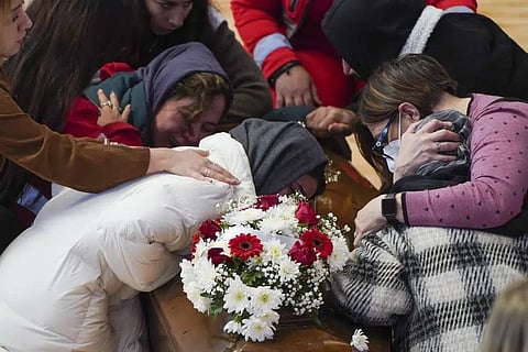 Relatives cry on the coffin of one of the victims of last Sunday's shipwreck at the local sports hall in Crotone, southern Italy, Wednesday, March 1, 2023. (Photo | AP)