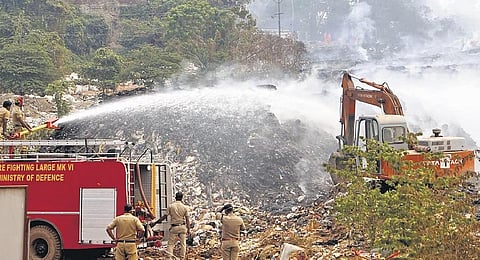 Fire and Rescue Services personnel try to douse the fire at Brahmapuram waste treatment plant in Kochi | Express