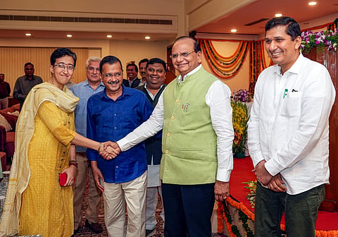 Delhi Lt Governor VK Saxena and Chief Minister Arvind Kejriwal (2nd from left) with newly sworn-in Delhi Cabinet Ministers Atishi Marlena (left) and Saurabh Bharadwaj. (Photo | PTI)