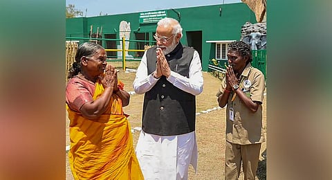 Prime Minister Narendra Modi meets Belli and Bomman during his visit to Mudumalai Tiger Reserve on Sunday. (Photo | PTI)
