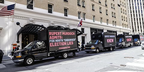 Truck billboards drive in front of the Palace Hotel calling out Fox News' election denial scheme in San Francisco, on March 08, 2023. (Photo | AFP)