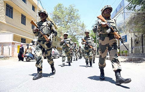  Border Security Force personnel and local police take out a route march in Ulsoor in Bengaluru on Monday, ahead of the Assembly elections. (Photo | Nagaraja Gadekal, EPS) 
