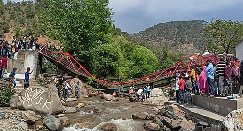 People gather after a footbridge collapsed during the Baisakhi celebration at Beni Sangam, in Udhampur, Friday, April 14, 2023.(Photo | PTI)
