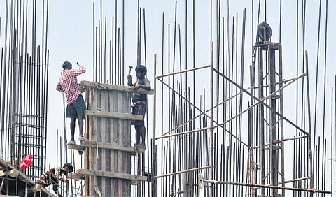 Migrant labourers working at a construction site under the scorching sun in the afternoon at Chakkai | B P Deepu