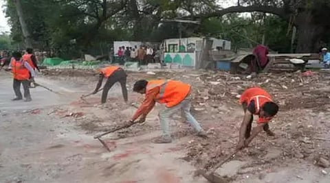 PWD workers remove debris during demolition work at a dargah on the Zakhir Hussain Marg in Delhi (Photo | PTI)