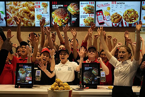 Employees of Rostic's restaurant in Tverskaya street celebrate opening ceremony in Moscow, Russia. (Photo | AP)