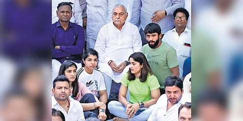 Former Haryana CM Bhupinder Singh Hooda (C) with wrestlers Vinesh Phogat, Sakshi Malik, and Bajrang Punia during the protest at Jantar Mantar on Tuesday. (Photo | Parveen Negi, EPS)