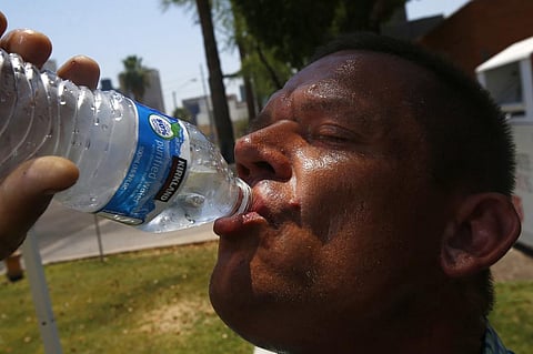 In this June 19, 2017 file photo Steve Smith takes a drink of water as he tries to keep hydrated and stay cool as temperatures climb to near-record highs, in Phoenix. (File photo | AP)