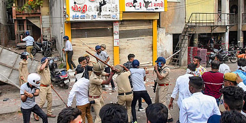 Police try to control a mob after incidents of stone pelting on a Ram Navami procession in Vadodara (Photo | PTI)