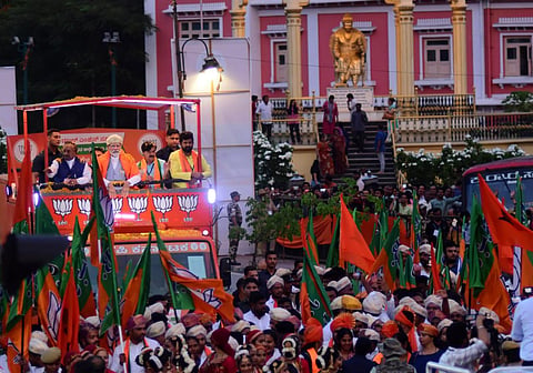 Prime Minister Narendra Modi wave at crowd during road show in heritage Mysuru city( Photo | EPS/ Udayashankar S)