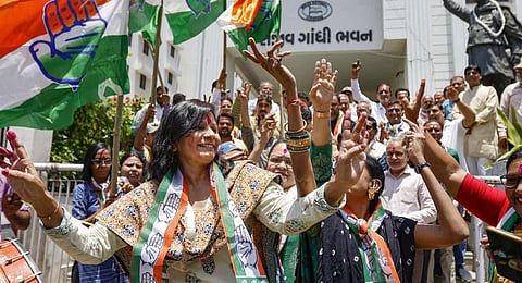 Congress workers celebrate at the party office after the party's decisive lead in the Karnataka Assembly elections, outside Rajiv Gandhi Bhavan in Ahmedabad. (Photo | PTI)