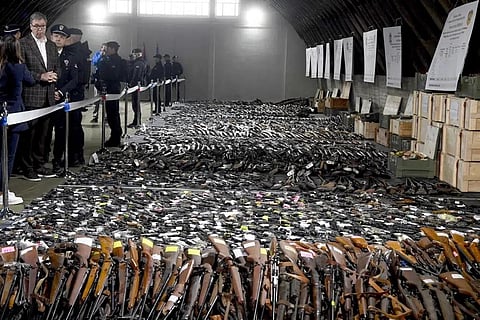 Serbian President Aleksandar Vucic, left, inspects weapons collected as part of an amnesty near the city of Smederevo, Serbia, May 14, 2023. (Photo | AP)