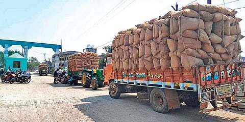 Farmers wait with their paddy stock at a procurement centre | Express
