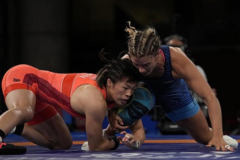 Risako Kawai, left, and United States Helen Louise Maroulis compete during the women's 57kg Freestyle semifinal wrestling match at the 2020 Summer Olympics, Aug. 4, 2021, in Japan. (File Photo | AP)