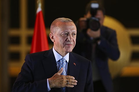Turkish President and People's Alliance's presidential candidate Recep Tayyip Erdogan gestures to supporters at the presidential palace, in Ankara. (Photo | AP)
