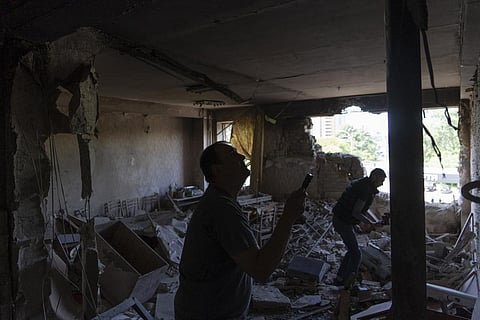 Men inspect their office damaged by a drone during a night attack, in Kyiv, Ukraine, Sunday, May 28, 2023. (Photo | AP)