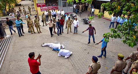 Special Investigation Team (SIT) and the forensic team recreate the crime scene, where three assailants shot dead gangster-turned-politician Atiq Ahmed (File photo | PTI)