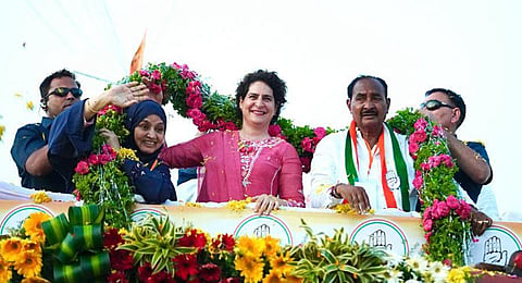 Congress general secretary Priyanka Gandhi Vadra being garlanded during a roadshow for the upcoming Karnataka Assembly elections, at Gulbarga.(Photo | ANI)