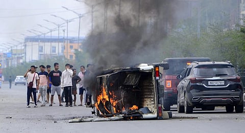 Smoke billows from a vehicle allegedly burned by the Meitei community tribals protesting to demand inclusion under the Scheduled Tribe category, in Imphal, May 4, 2023. (Photo | AFP)