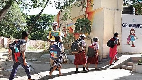 A traffic cop welcomes the students back to the Government Public School, Irrum Manzil, as schools reopened for the new academic year after summer holidays across Telangana | Sri Loganathan Velmurugan