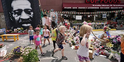 Preschool children visit the site where George Floyd was murdered by then Minneapolis Police officer Derek Chauvin, as the kids took a field trip to the memorial. (File Photo | AP)
