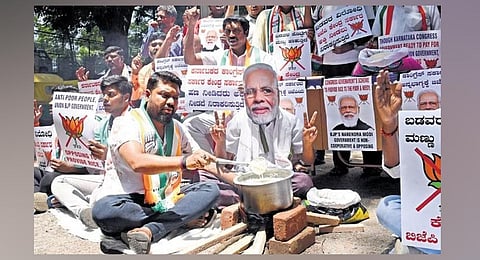 Youth Congress members protest against the Centre for discontinuing the sale of rice and wheat from its pool, in Bengaluru on Friday | Vinod Kumar T