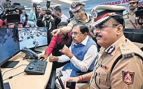 Home Minister G Parameshwara inspects CCTV footage during his visit to the office of the City Police Commissioner on Friday.