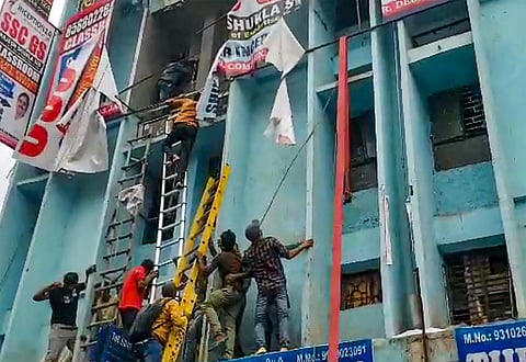 Students being rescued after a fire broke out at a coaching institute, at Mukherjee Nagar. (Photo | PTI)