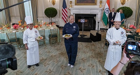 White House chefs Cristeta Comerford (L), Susan Morrison (R) and guest chef Nina Curtis hold dishes during a media preview on Wednesday, June 21, 2023. (Photo | AP)