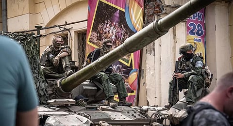 Members of Wagner group sit atop of a tank in a street in the city of Rostov-on-Don, on June 24, 2023.(Photo | AP)