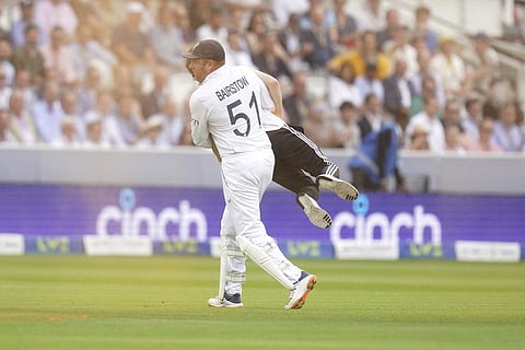 England's Johnny Bairstow carries a Just Stop Oil protestor off the pitch, during day one of the second Ashes Test cricket match at Lord's Cricket Ground in London, June 28, 2023. (Photo | AP)