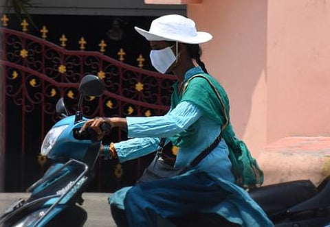 Motorists protect themselves from scorching heat in Tirupati on Friday. (Express Photo by Madhav K)