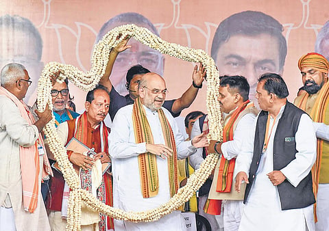 Home Minister Amit Shah, along with Bihar BJP chief Samrat Choudhary and state LoP Vijay Kumar Sinha, at a rally in Lakhisarai, Bihar. (Photo | PTI)