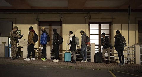 Migrants line up to be checked by Italian authorities (Photo | AP)