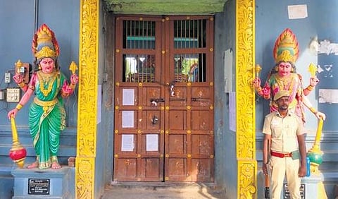 A policeman guarding the sealed Sri Dharmaraja Draupadi Amman Temple at Melpathi village on Wednesday | Express