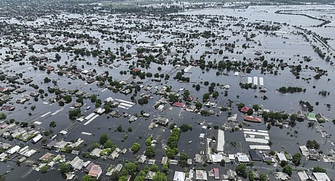 Houses are seen underwater in the flooded town of Oleshky, Ukraine. (Photo | AP)