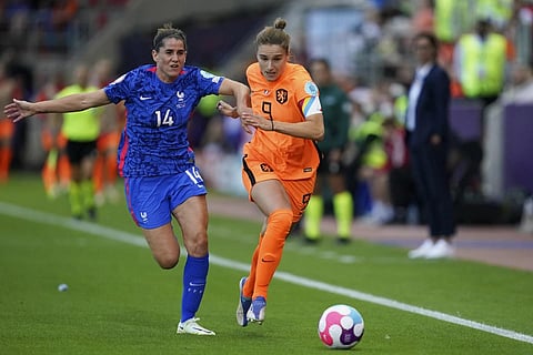 Netherland's Vivianne Miedema runs with the ball pursued by France's Charlotte Bilbault, left, during the Women Euro 2022 quarterfinals match in Rorherham, England, July 23, 2022. (File Photo | AP)