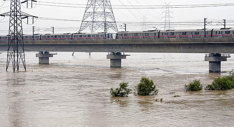 A Delhi Metro train moves slowly over the bridge spanning the swollen Yamuna river, in New Delhi, Thursday, July 13, 2023.(File Photo | PTI)