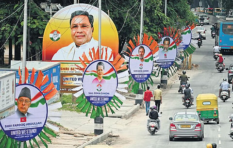Hoardings with pictures of opposition leaders being put up in Bengaluru on the eve of the two-day opposition conclave, on Sunday. Leaders of 24 political parties will be present | Shashidhar Byrappa