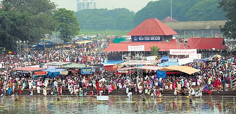 Devotees offering Bali tharpan to their ancestors at Aluva manappuram. (Photo | T P Sooraj)