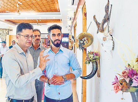 Artist Aziz-ur Rehman (right) at an exhibition showcasing his work at Kashmir Arts Emporium in Srinagar | Express