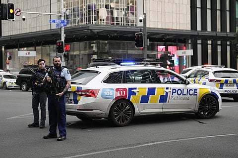 Armed New Zealand police officer stand at a road block in the central business district following a shooting in Auckland, New Zealand, Thursday, July 20, 2023. (Photo | AP)
