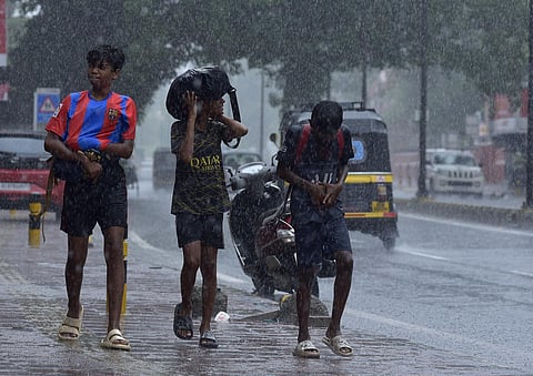 Three boys walk home drenched after their football practice in Kochi. (Photo | A Sanesh, EPS)