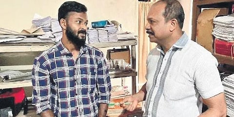 Noushad with a police officer at the Thodupuzha police station