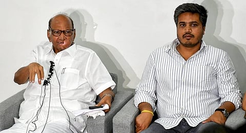 NCP President Sharad Pawar with party MLA Rohit Pawar speaks during a press conference at his residence, in Pune, Sunday, July 2, 2023. (Photo | PTI)