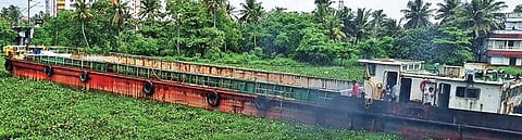 The barge of FACT stuck near Kaniyampuzha bridge. The waterway is filled with water hyacinth