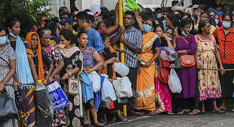 People queue up to buy kerosene for domestic use at a supply station in Colombo. (Photo | AFP)