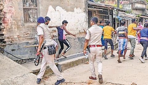 Police personnel baton charge after a clash between rival groups during panchyat elections, at Nagaria village in Malda district of Bengal on Saturday | PTI